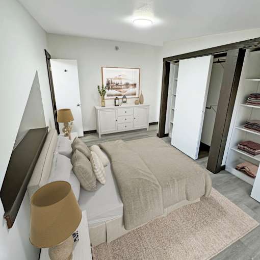 A bedroom with a bed, dresser, and wardrobe.