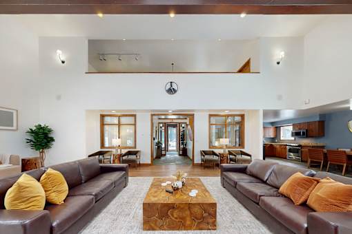 A living room with brown leather couches and a coffee table in the center.