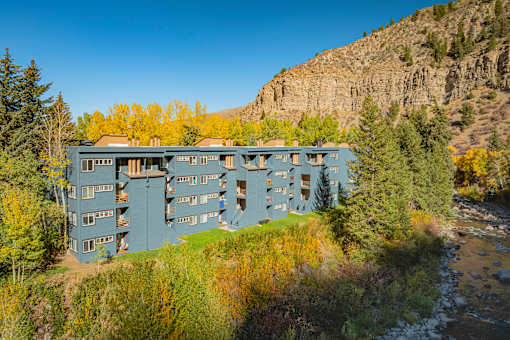 A large building with many windows is situated on a hillside.