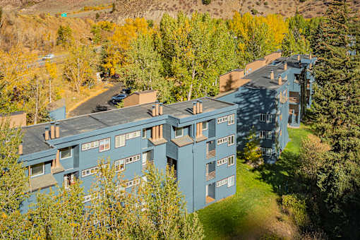 A large building with a green lawn in front of it.