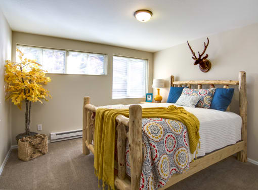 a bedroom with a bed and a large window