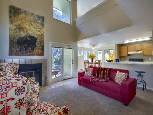 a living room with a red couch and a fireplace