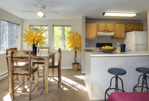 a kitchen and dining room with a table and chairs