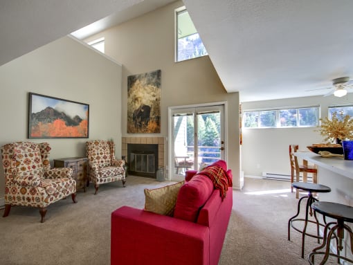 a living room with a couch and chairs and a fireplace