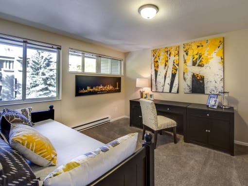 a bedroom with a bed and a desk and a fireplace