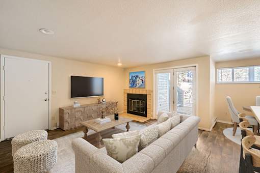 A living room with a fireplace and a television.