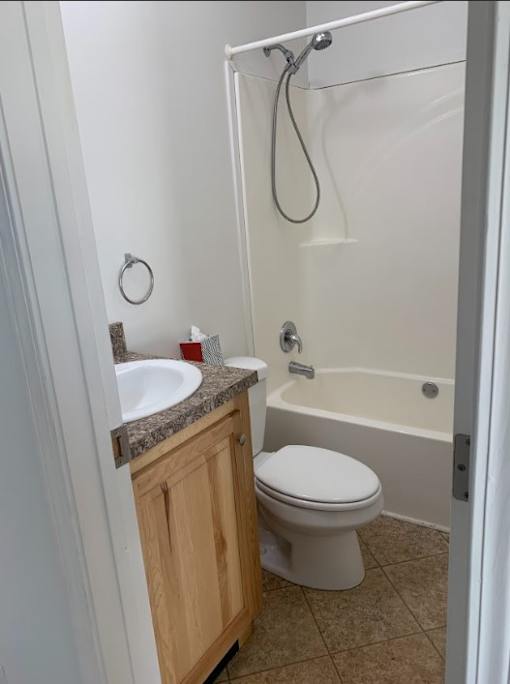 a bathroom with a toilet and a sink and a shower