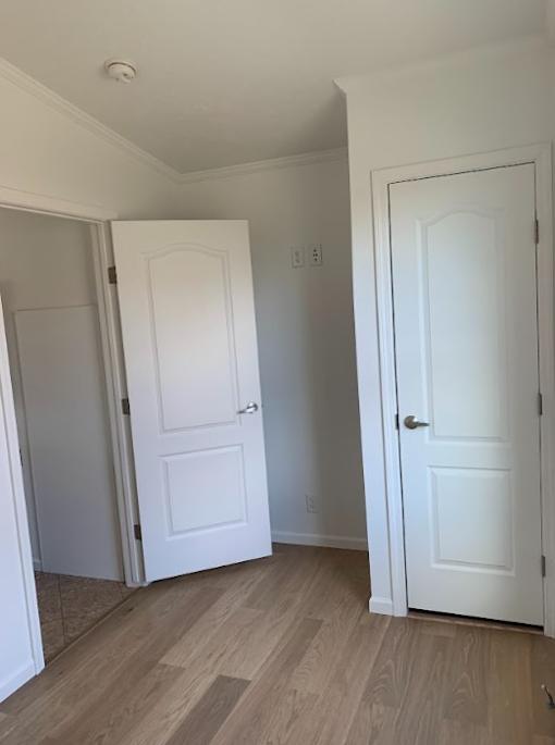 a room with two white doors and a wood floor
