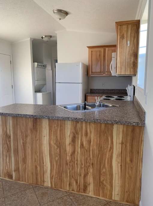 a kitchen with a sink and a refrigerator