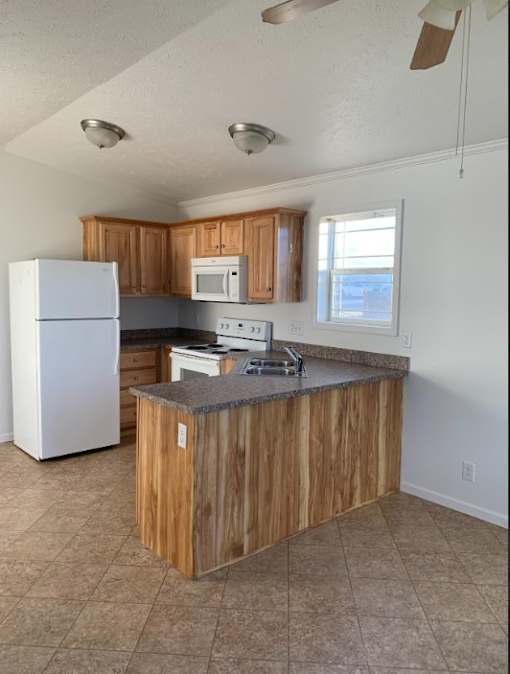 a kitchen with a counter top and a refrigerator