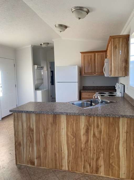 a kitchen with a sink and a refrigerator