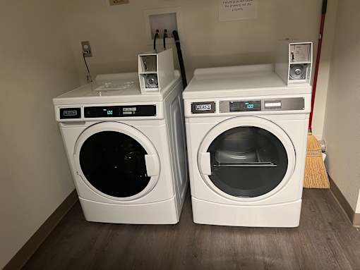 two washing machines next to each other in a room