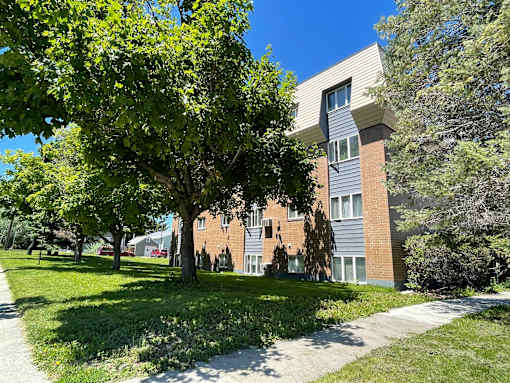 a large brick building with trees in front of it