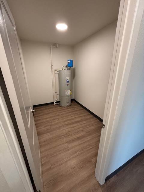 A white air conditioning unit is installed on a wooden wall.