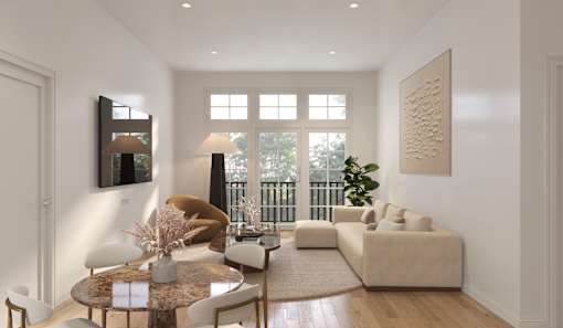 A modern living room with a brown sofa, a round table, and a large window.