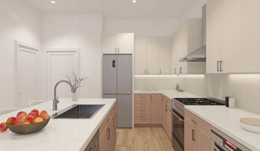 A modern kitchen with a bowl of apples on the counter.