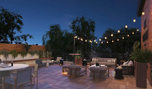 A patio with a table, chairs, and string lights.