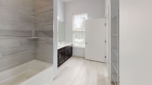 a bathroom with a tub and a shower and a sink