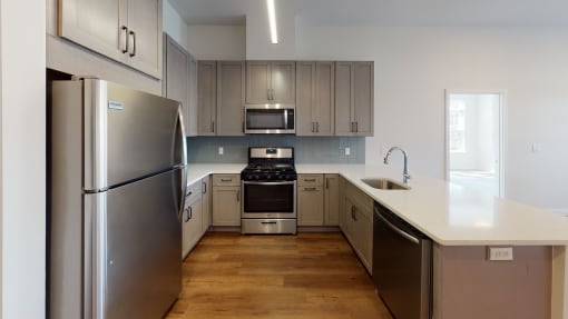 a kitchen with stainless steel appliances and white counter tops