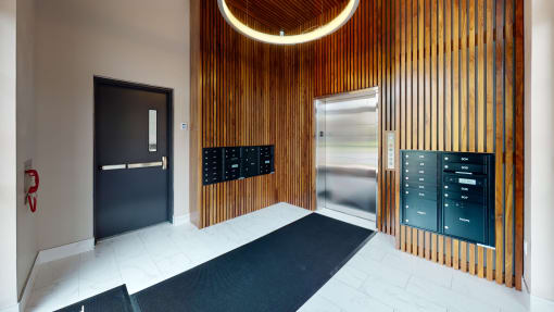 a view of a hallway with a door to a locker room and a lockers