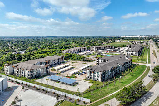 an aerial view of an apartment complex in a city at Creekside at Grand Prairie, Grand Prairie, 75052
