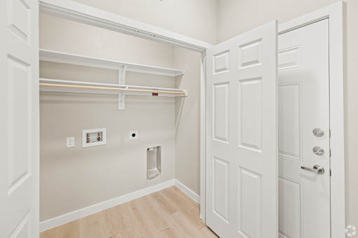 a bedroom with a closet and a door to a bathroom at Creekside at Grand Prairie, Grand Prairie, TX