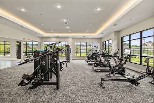 a gym with cardio equipment and windows in a large room at Creekside at Grand Prairie, Grand Prairie, Texas, 75052