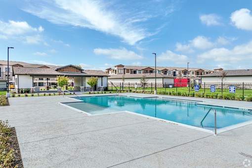 the preserve at ballantyne commons community swimming pool with apartment buildings in the background at Creekside at Grand Prairie, Grand Prairie, Texas, 75052
