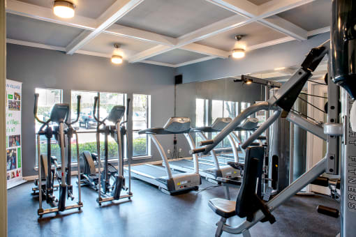 a gym with treadmills and other exercise equipment at Infinity on the Mark, Dallas, Texas
