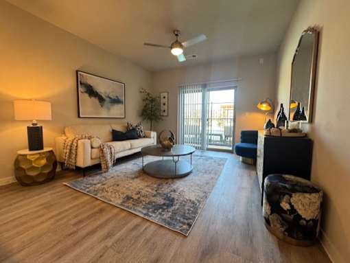 A living room with a white couch, a round table, and a rug at Arden at Corinth, Corinth, TX, 76210
