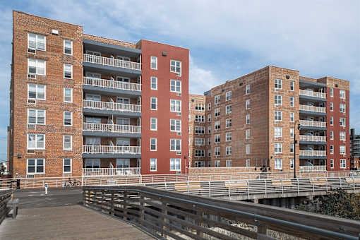 A red brick building with a balcony on the second floor.