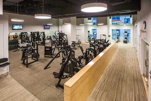 A gym with a variety of equipment including treadmills, weights, and exercise machines.at 'The Metropolis', New York, 10017 