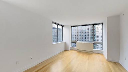 A large empty room with a window overlooking a cityscape.at 'The Metropolis', New York 