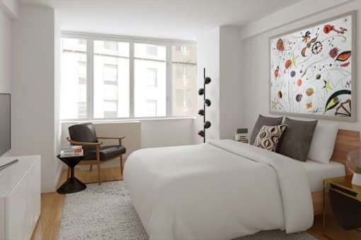 A bedroom with a large bed, a chair, and a painting on the wall.at 'The Metropolis', New York, NY 10017 