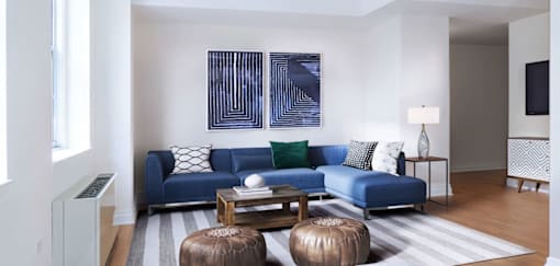 A living room with a blue couch and a coffee table.at 21 West, New York 