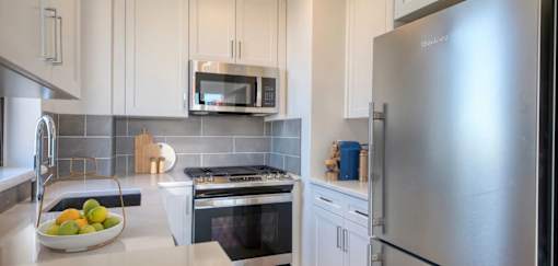 A modern kitchen with a stainless steel refrigerator.at 301E94, New York 