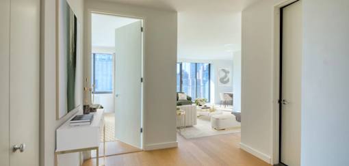 A white door is open to a living room.at 301E94, New York, NY 10128 