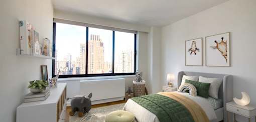 A bedroom with a large bed and a cat on the floor.at 301E94, New York, 10128
