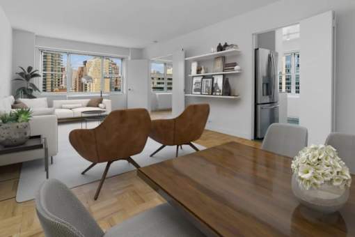 A modern living room with a wooden table and chairs at The Caldwell Apartments, New York