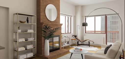A living room with a fireplace and a large mirror on the wall at The Ellington Apartments, New York, 10019