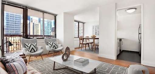 A modern living room with a view of the city at The Ellington Apartments, New York, New York