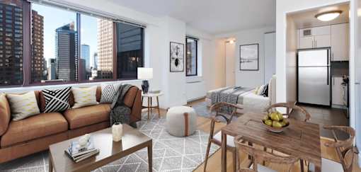 A modern living room with a brown sofa and a wooden coffee table at The Ellington Apartments, New York