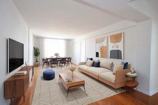 A living room with a couch, a coffee table, and a television.