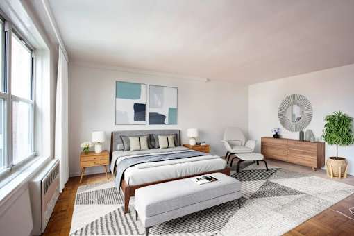 A bedroom with two beds, a chair, a dresser, and a plant.