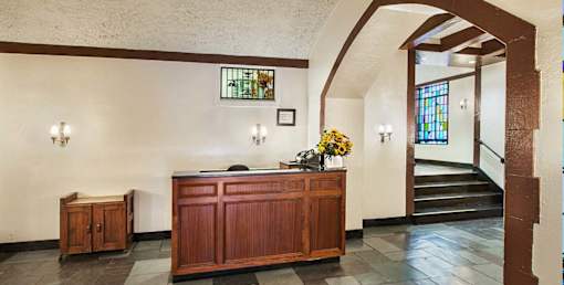 apartment community interior with a wooden pulpit and a stained glass window. at Sutton Collection Apartments, New York, 10022