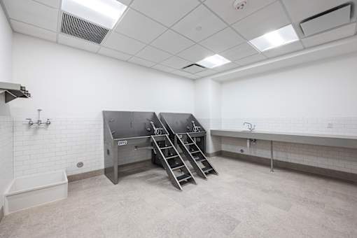 a large room with a stainless steel counter top and a sink