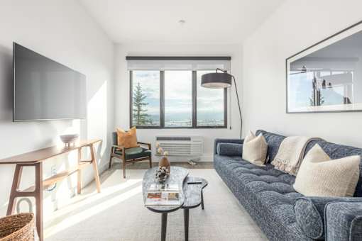 a living room with a blue couch and a tv