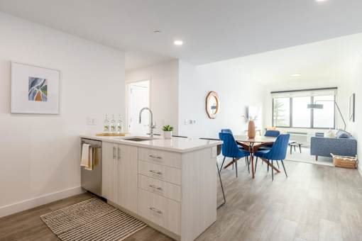 a kitchen and dining area with a table and chairs