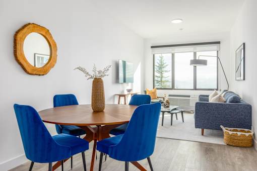 a dining room with blue chairs and a wooden table