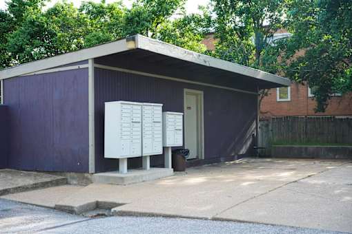 A small building with a purple exterior and a white door.